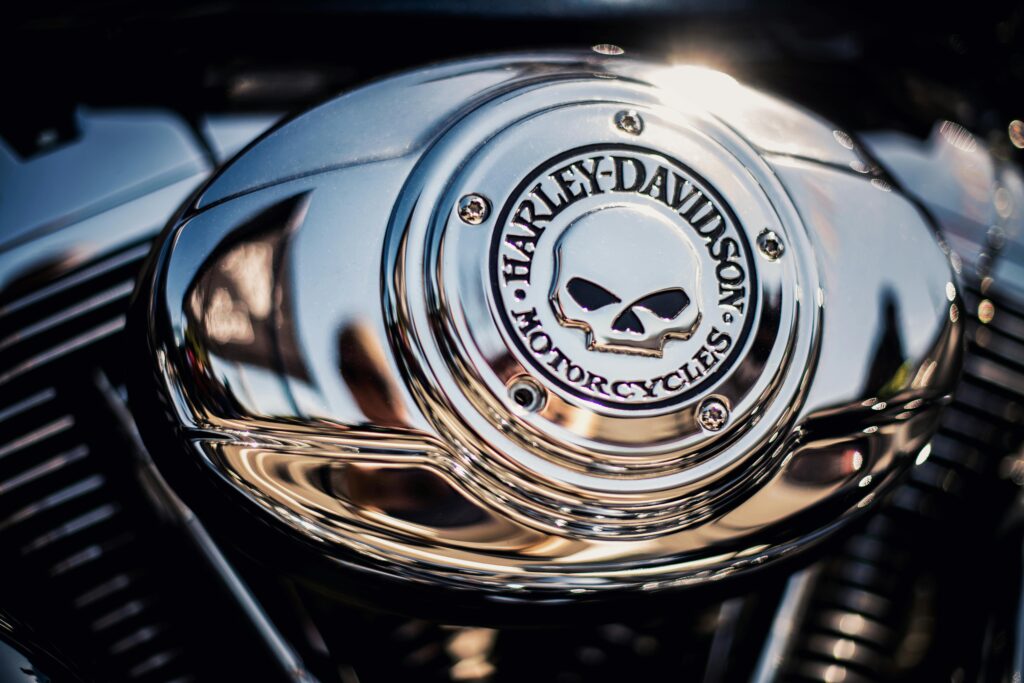 Detailed view of a chrome Harley Davidson motorcycle engine with iconic skull logo.