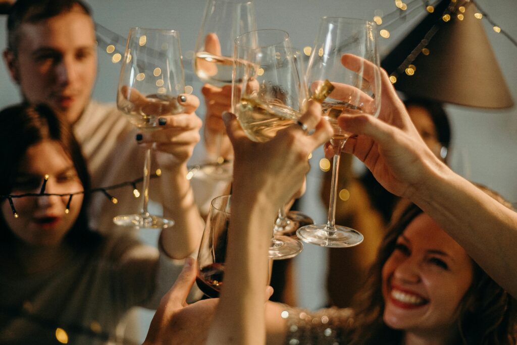 A group of friends joyfully toasting with champagne glasses at a festive celebration.
