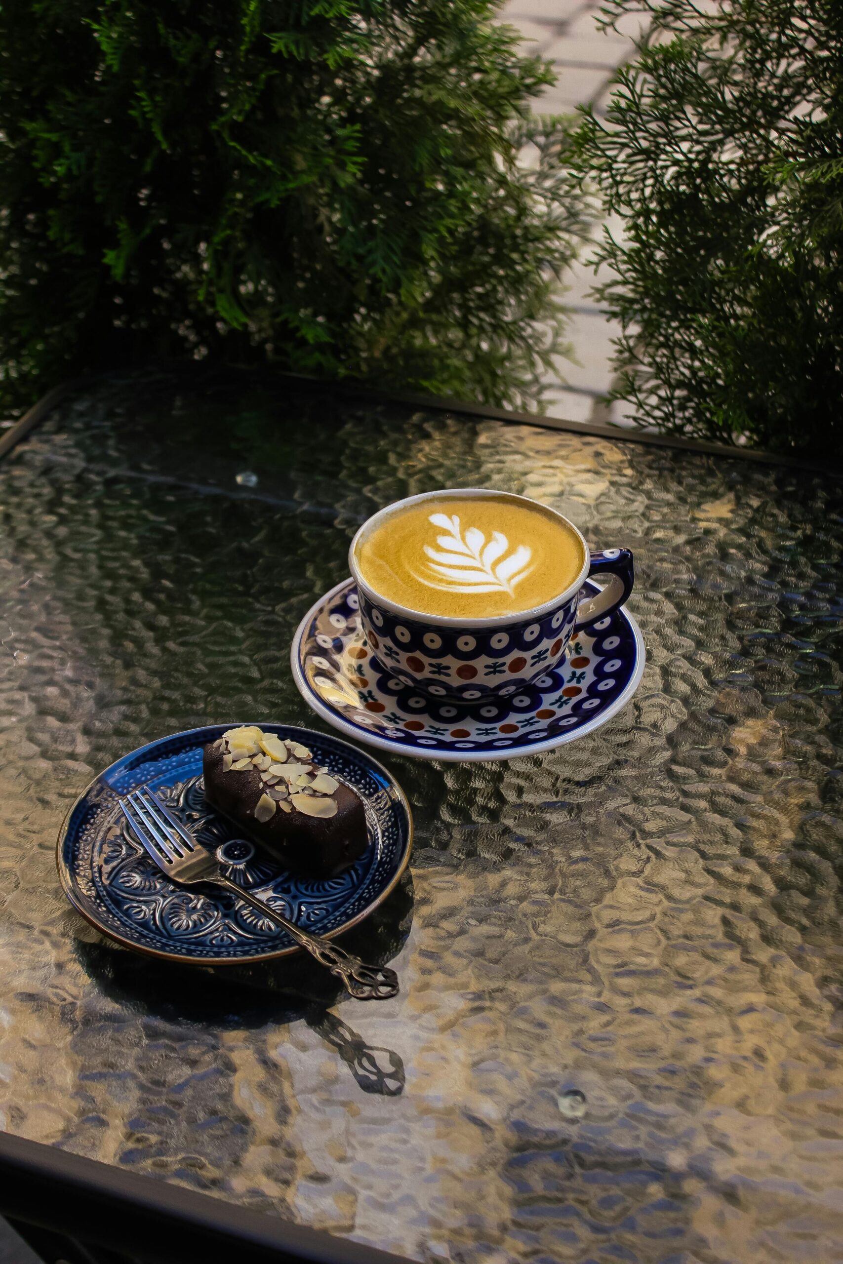 Charming latte art served on a glass table in Wrocław café, Poland. Perfect for coffee enthusiasts.